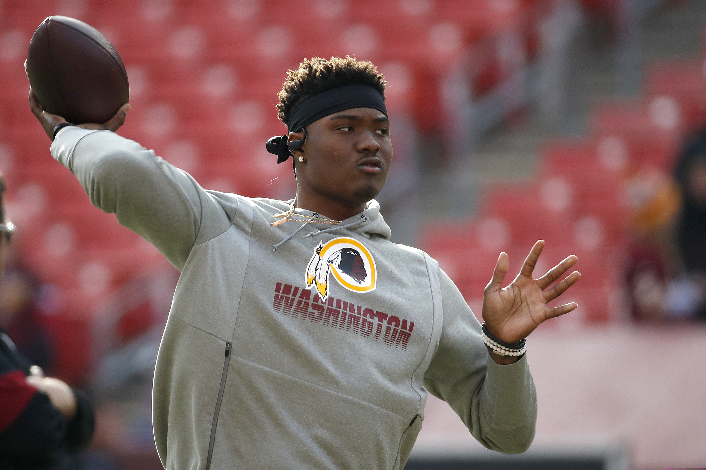 Washington Football Team quarterback Dwayne Haskins warms up during his rookie season, the final year the team employed a mascot considered to be a racial slur against Native Americans.