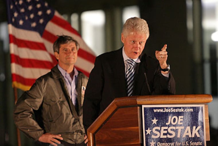 Former President Bill Clinton talks to Temple University students Thursday night as Democratic candidate for Senate Joe Sestak listens. (Yong Kim / Staff Photographer)
