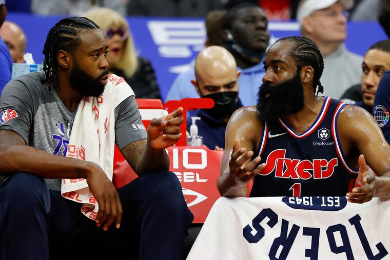 Sixers center DeAndre Jordan (left) talks to teammate James Harden on the bench on Monday.