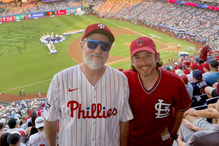 Mike Harkins (left) handed out physical ticket stubs to fans at Tuesday's All-Star Game at Citizens Bank Park.
