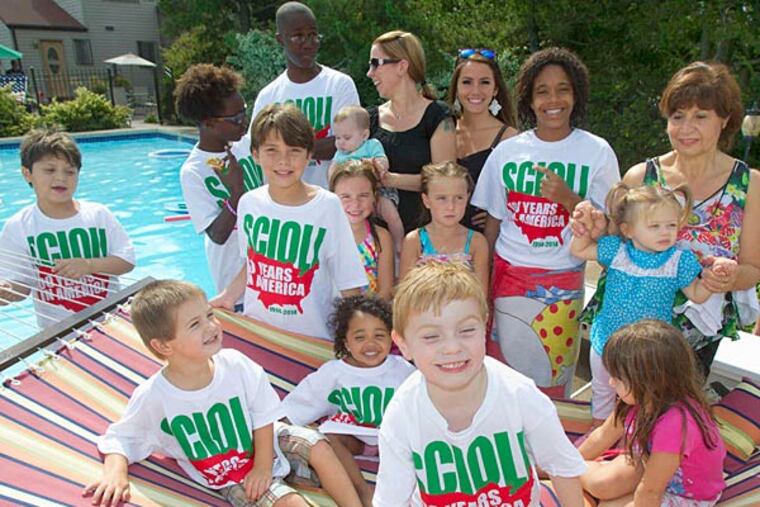 Members of the Scioli family pose for a photo at a reunion marking when family ancestors immigrated to Phila. (Charles Fox/Staff Photographer)