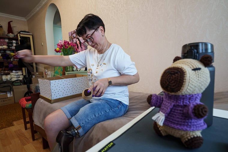 Iryna Nakonechna knits a toy capybara at her home in Kryvyi Rih, Ukraine, Saturday, May 9, 2026. (AP Photo/Evgeniy Maloletka)