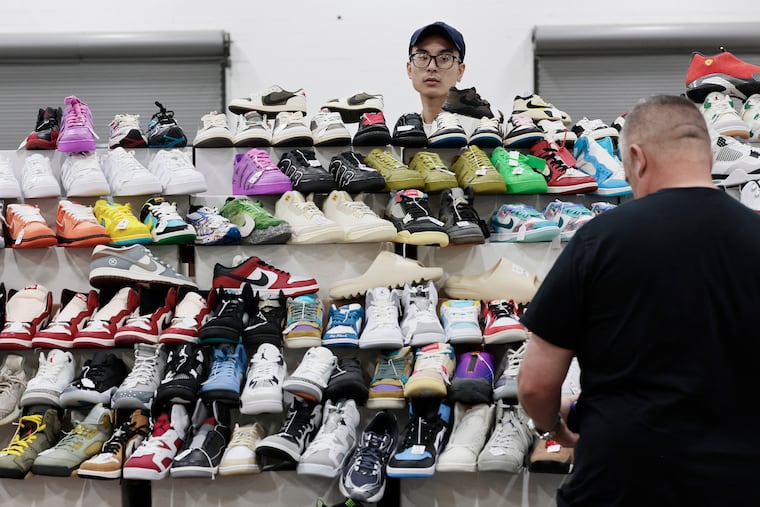Phuong Tran keeps an eye on customers at the Got Sole sneaker event at the Greater Philadelphia Expo Center on Saturday.