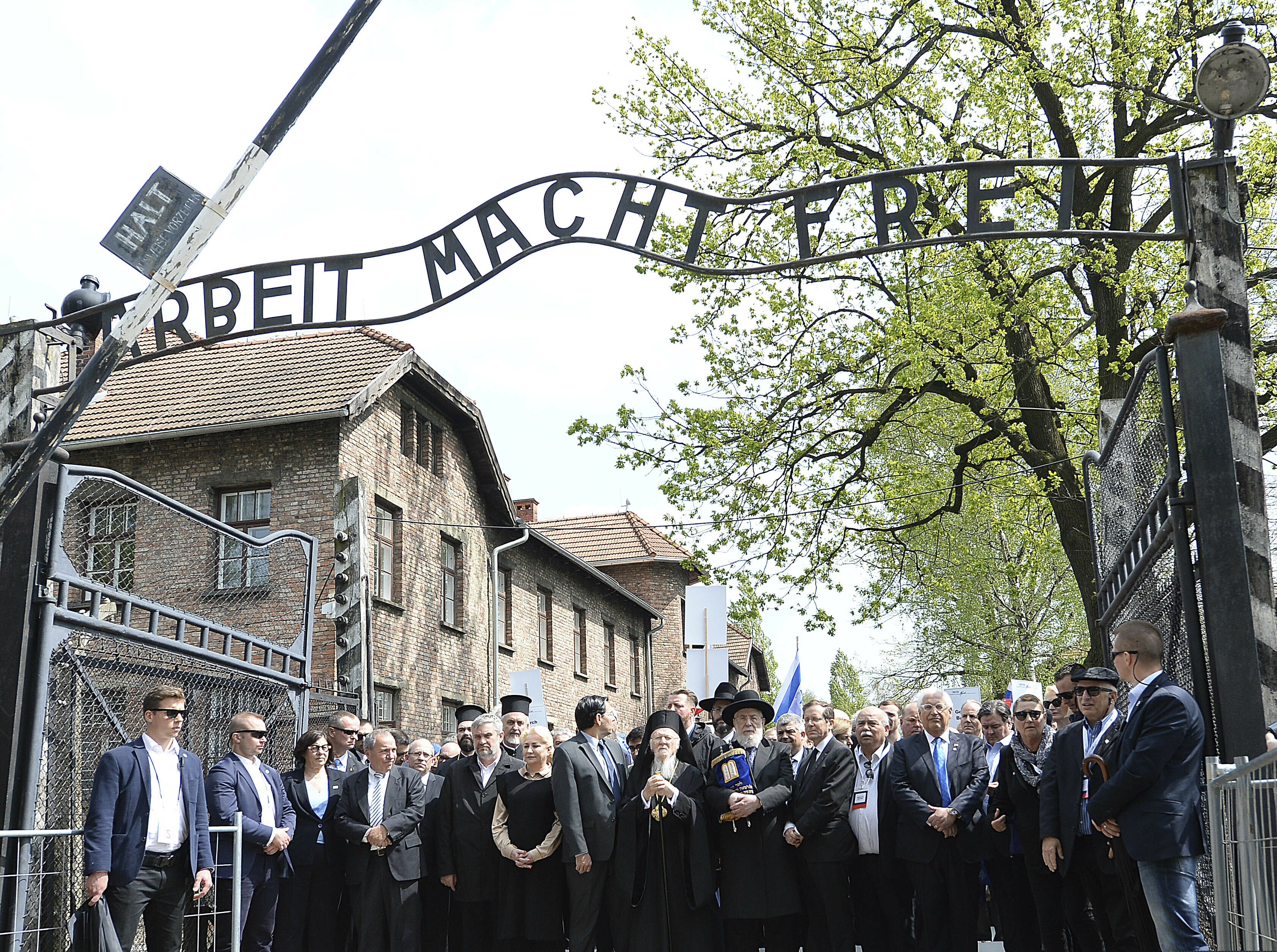 Politicians leading the Holocaust remembrance "March of the Living" for the six million for Holocaust victims walk through the "Arbeit Macht Frei" (Work Sets You Free) gate at the start of the march between the parts of the former Nazi German death camp of Auschwitz-Birkenau in Oswiecim, Poland, Thursday, May 2, 2019. (AP Photo/Czarek Sokolowski)