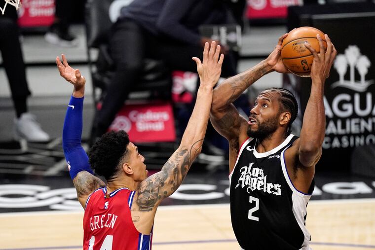 Los Angeles Clippers forward Kawhi Leonard, right, shoots as Sixers forward Danny Green defends Saturday night.