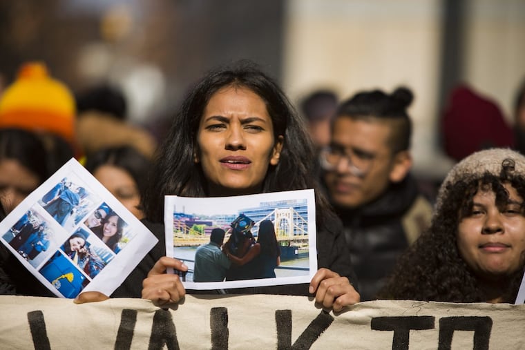 Maria Duarte holds up a photo of her family as she makes her way to the Liberty Bell. She is one of 11 Dreamers making a 250-mile walk from New York City to Washington, DC to raise awareness and support the DREAM Act, February 20th, 2018.