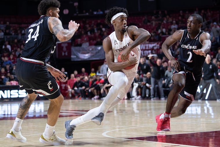 Quinton Rose drives to the basket pats Cincinnati's Jarron Cumberland (left) and Keith Williams during Temple's loss to the Bearcats on Sunday.