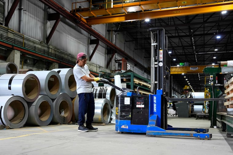 A worker operates a forklift in front of steel coils at the manufacturing plant of Ideal Roofing in Ottawa on Tuesday, Aug. 25, 2026.