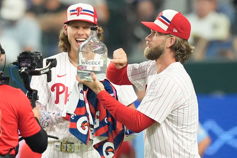 Alec Bohm (left) jokes with teammate Bryce Harper during the All-Star Home Run Derby on Monday night.