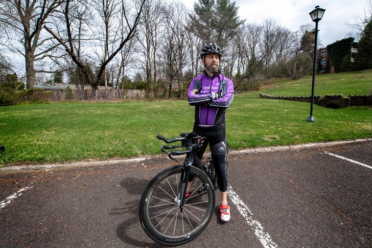 Cancer survivor and heart-transplant recipient Derek Fitzgerald pauses near his home in Doylestown. Now a healthy triathlete, he will ride a stationary Peleton bike for 24 hours straight on May 22 to raise money for the Leukemia and Lymphoma Society.