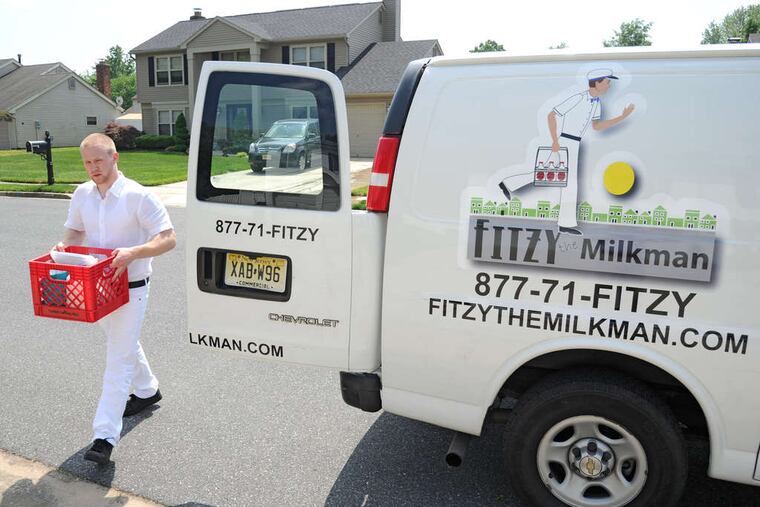 Kevin Decker carries a crate of goods to a house in Mount Laurel. His mother, Christie Arleo, startedthe business with an eye to passing it along to him eventually.