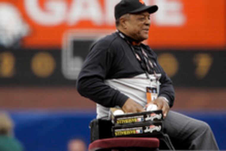 Riding in a 1958 Cadillac, Willie Mays prepares to throw out souvenir baseballs before the All-Star Game in San Francisco, where he was honored.