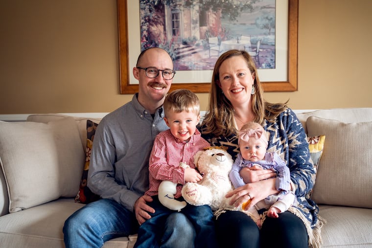 Andrew and Alexis with Edgar, Valerie, and a stuffed teddy bearing the name of Adeline Kelly, the twin who died.