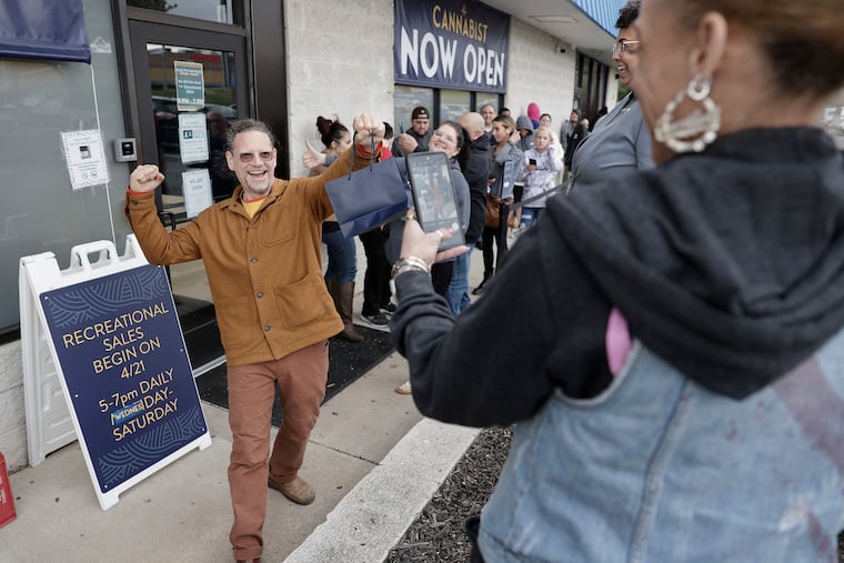 Frank Burkhauser of Woodbury handed his phone to Cannabist employee Jennifer DeWalt so he could have a photo to remember this day that he made a legal marijuana purchase at Cannabist in Deptford, N.J. on April 21, 2022. Burkhauser said he has been working for the legalization of marijuana since the early 90’s.
