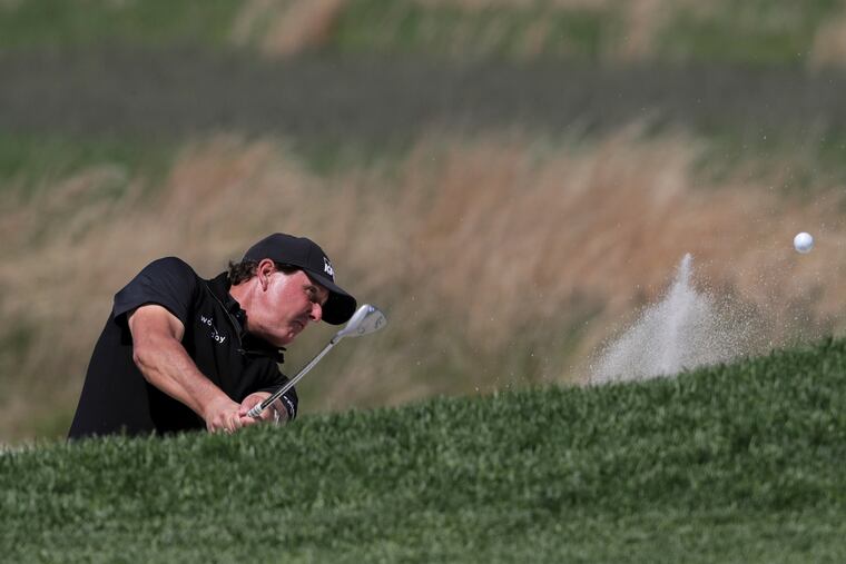 Phil Mickelson hits out of a bunker on the 11th hole during the third round of the PGA Championship golf tournament, Saturday, May 18, 2019, at Bethpage Black in Farmingdale, N.Y. (AP Photo/Charles Krupa)