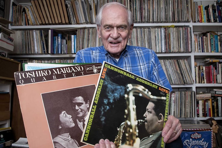 Gil Sokolow holds a few of the 2,000-plus jazz recordings he has collected over the past 70 years.