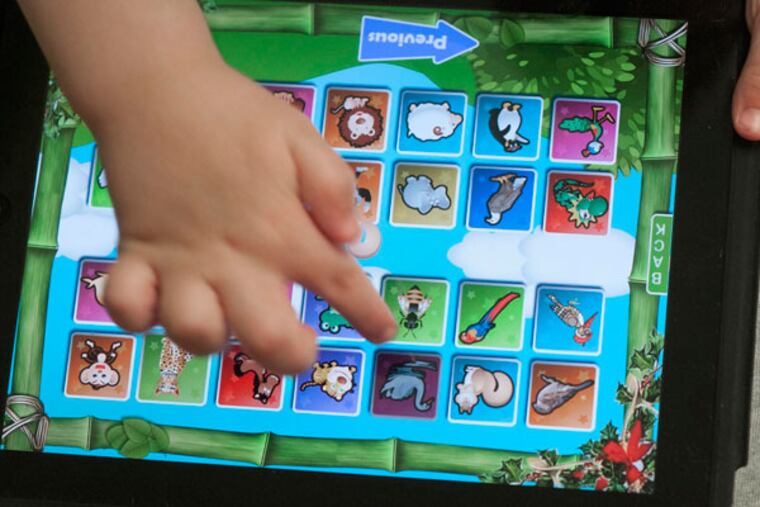 Liam Stemple, 3, works on an iPad Thursday April 18, 2013 at the Highlands Center for Autism in Prestonsburg, Kentucky. (John Flavell/Lexington Herald-Leader/MCT)