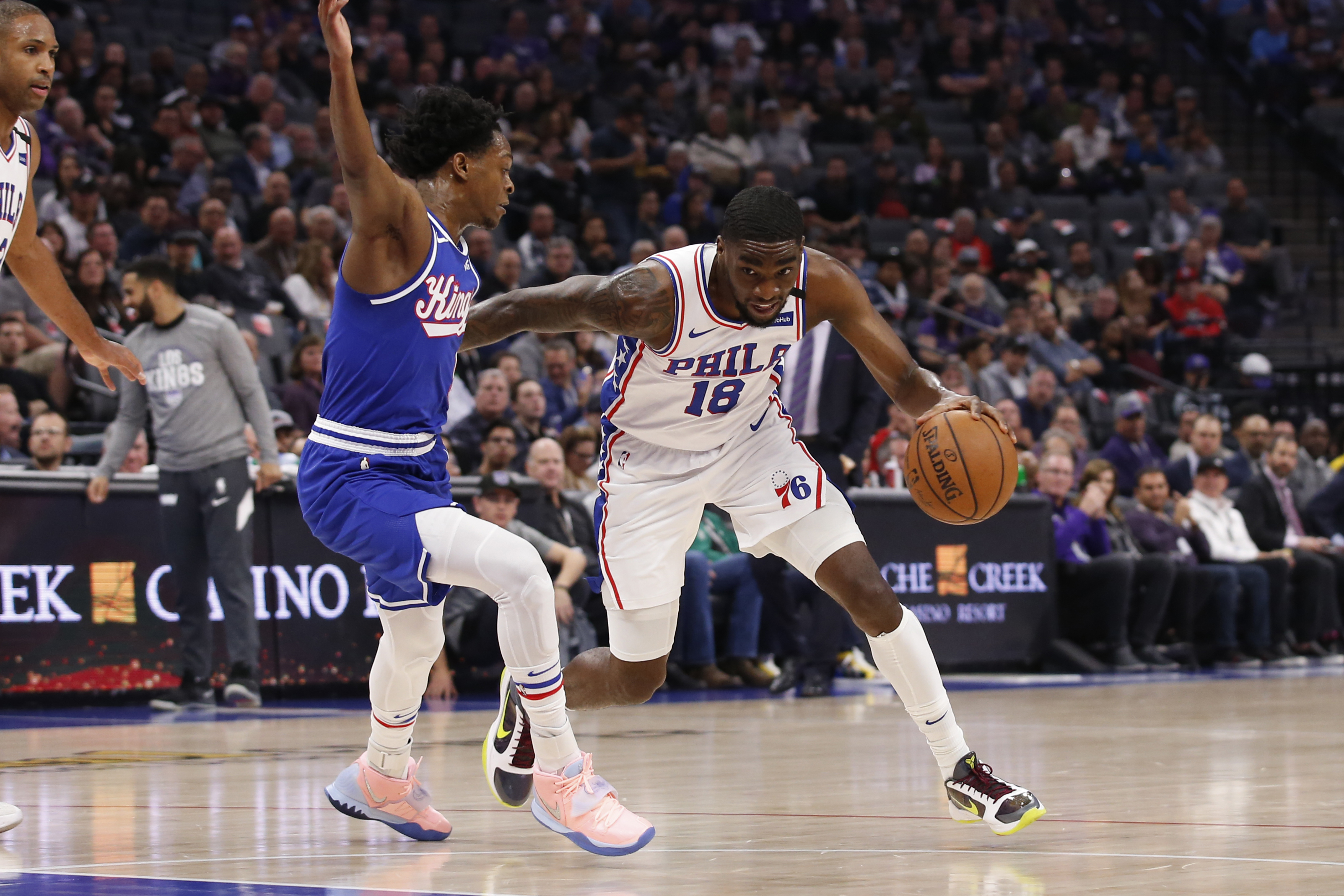 Sixers guard Shake Milton, right, drives against Sacramento Kings guard De'Aaron Fox during Thursday's game.