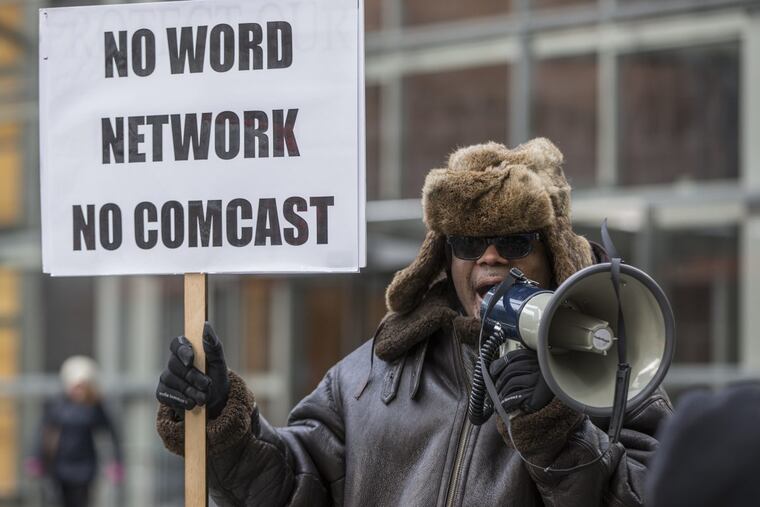 Reverend W. J. Rideout III, pastor of All Gods People Church from Detroit, uses the bullhorn to spur his congregation to chant in front of the Comcast Center in January 2017.