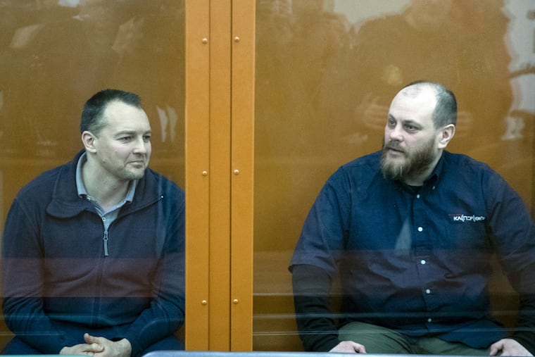 The former chief of the cybercrime department at Russia's main domestic security agency Sergei Mikhailov, left, and the former employee of Kaspersky Lab cybersecurity firm Ruslan Stoyanov attend a hearing in a court in Moscow, Russia, Tuesday, Feb. 26, 2019. Moscow's District Military Court stripped Sergei Mikhailov of his colonel's rank and ordered him to pay a 400,000-ruble ($6,130) fine and handed a 14-year sentence to Ruslan Stoyanov who was charged in the same case. (AP Photo/Pavel Golovkin)
