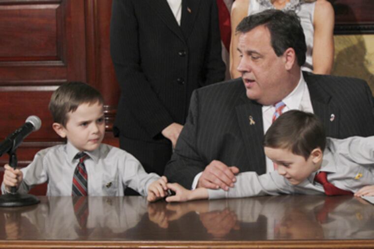 Gov. Christie with 5-year-old twins Brandon (left) and Jesse Koczon. After a
YouTube video of Jesse went viral last week, Christie invited them to Trenton. (Mel Evans / AP Photo)