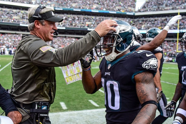 Eagles head coach Doug Pederson congratulates rookie running back Corey Clement.