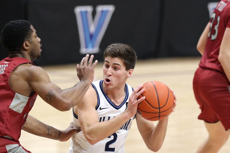 Villanova's Collin Gillespie drives against St. Joseph's Rahmir Moore on Dec. 19, 2020 at the Finneran Pavilion. The Wildcats had to put a pause on their season soon after due to positive COVID-19 cases.