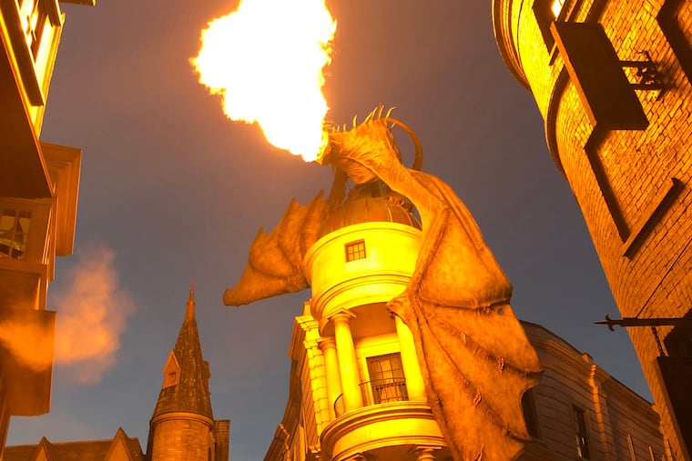A fire-breathing dragon perches atop Gringotts Bank in Diagon Alley at the Wizarding World of Harry Potter at Universal Orlando Resort.