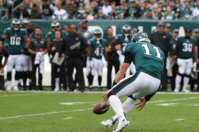 Eagles quarterback Carson Wentz chases the ball down after a high snap goes over his right shoulder during the first quart of the game against the New York Jets on Sunday, October 6, 2019 at Lincoln Financial Field in Philadelphia.