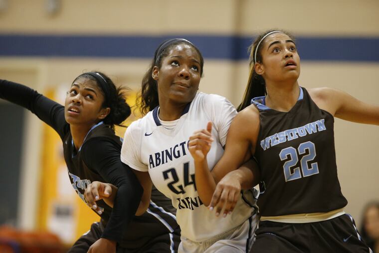 Abington Friends senior Alexa Middleton, center, battles for rebounding position against Westtown players including Naomi Jimenez, right, during a game on Feb. 9, 2016.