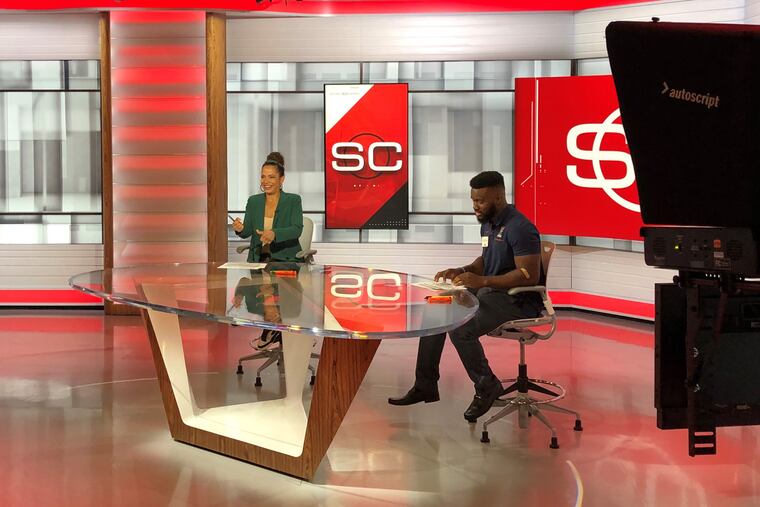 Penn football player Karekin Brooks (right) and ESPN anchor Elle Duncan before they filmed a mock highlight package at Ivy League media day at ESPN headquarters on Thursday.