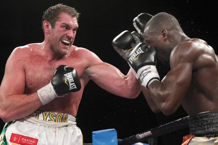 Tyson Fury (left) lands a punch on Steve Cunningham during a heavyweight boxing match, Saturday, April 20, 2013 at the Theatre at Madison Square Garden in New York. Fury knocked out Cunningham in the seventh round. (Mary Altaffer/AP)