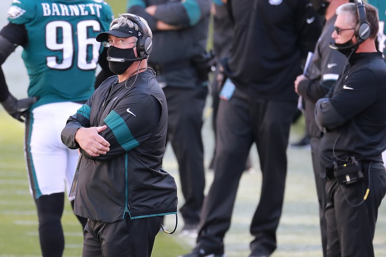 Eagles coach Doug Pederson watches the replay after the Rams intercepted a pass late in the fourth quarter.