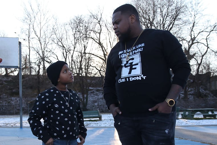 Eric Lawton, right, and his son, Shawn, 7, stand for a portrait at the Happy Hollow Recreation Center in Germantown on Thursday, Jan. 18, 2018. The two star in popular Instagram videos posted to Lawton's account, GheeFunny.