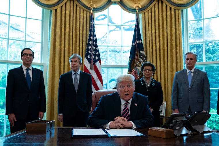 President Donald Trump speaks before signing a coronavirus aid package to direct funds to small businesses, hospitals, and testing.