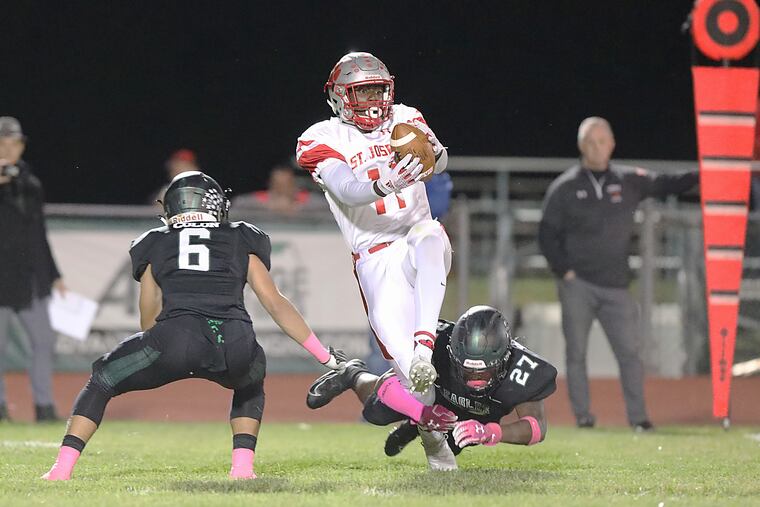 St. Joseph's Keshon Griffin tries to hold on to a long pass while being tackled by West Deptford's Tyshawn Bookman.