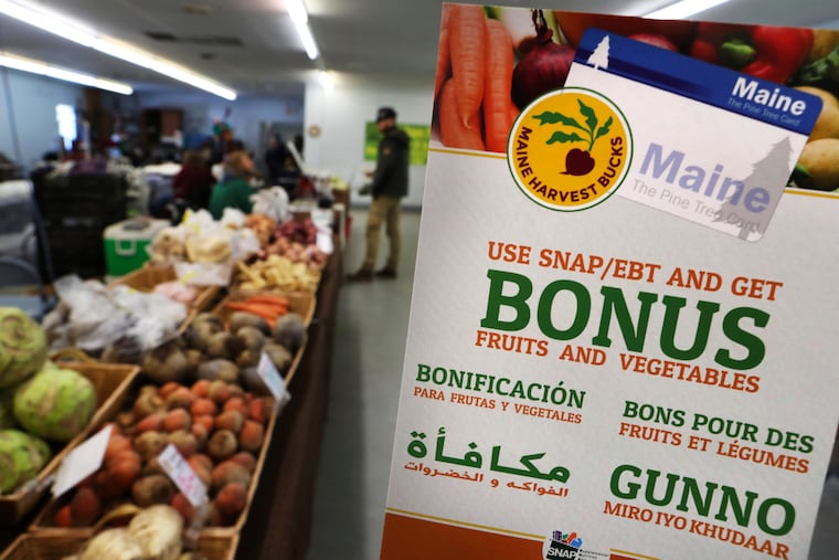 A sign advertises a program that allows food stamp recipients to use their EBT cards to shop at a farmer's market in Topsham, Maine.