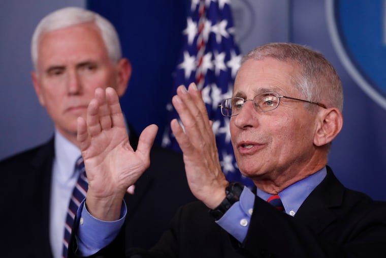Dr. Anthony Fauci, director of the National Institute of Allergy and Infectious Diseases, speaks about the coronavirus as Vice President Mike Pence listens.
