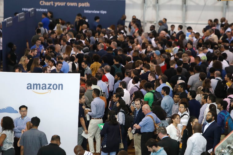 Job seekers line up to speak to recruiters during an Amazon job fair in Dallas, Texas in September 2019. Pennsylvania's unemployment rate ticked upward by one-tenth of a percentage point to 4.7% in January, the state Department of Labor and Industry said Friday.