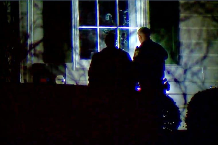 Officials inspect broken windows and other property damage at Vice President JD Vance's Ohio home in eastern Cincinnati on Monday.