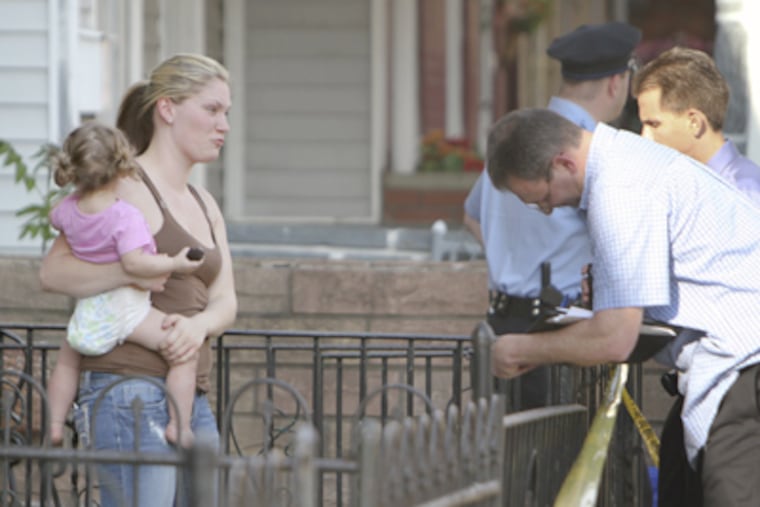 Britney Britton, left, talks with police Monday after an off-duty police officer shot her boyfriend, Josh Taylor. (Joseph Kaczmarek / For the Daily News & Inquirer)