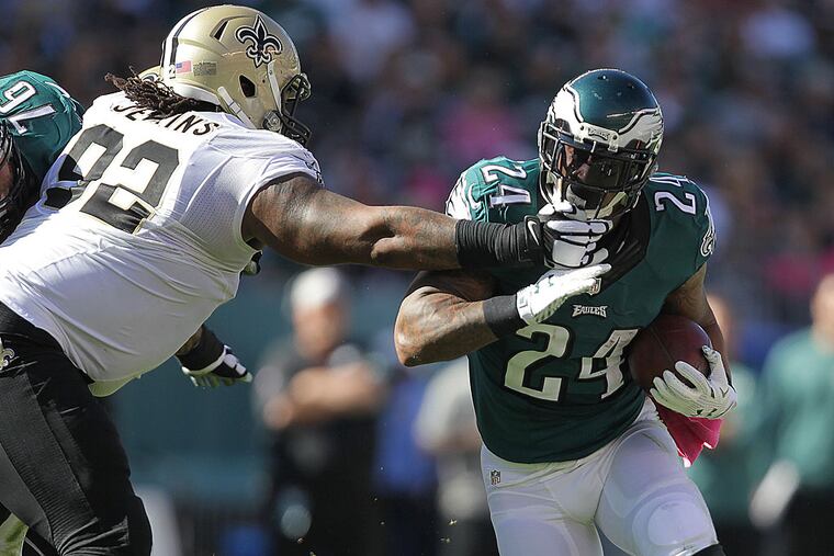 The Saints' John Jenkins reaches out for Ryan Mathews.