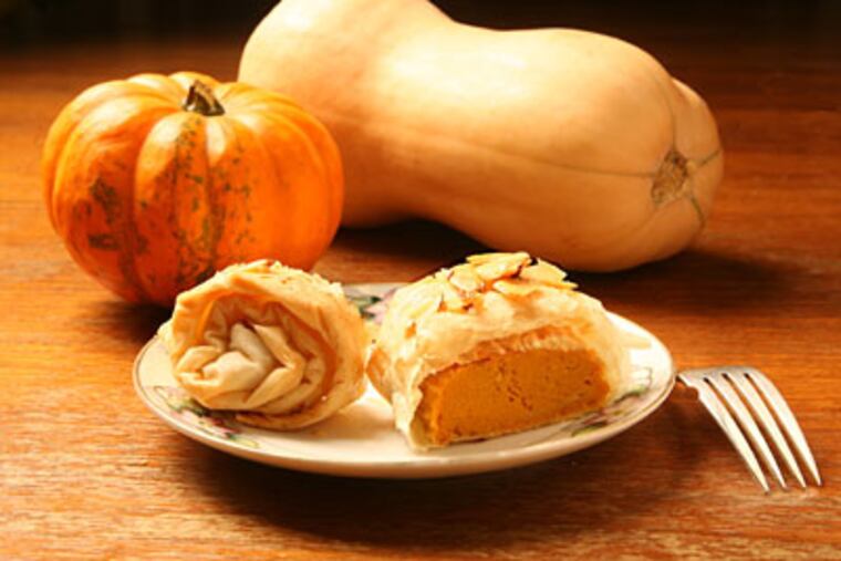 Pumpkin almond strudel, surrounded by a variety of squashes. (CHARLES FOX / Staff Photographer)