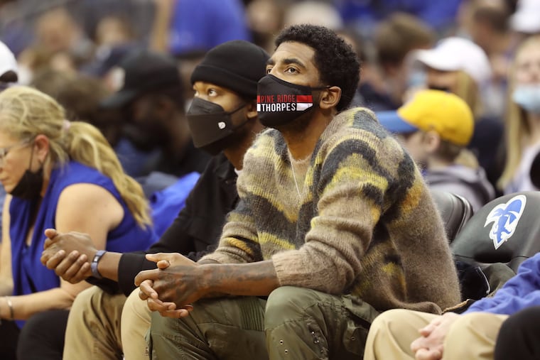 Brooklyn Nets guard Kyrie Irving watches a Villanova-Seton Hall game in January.