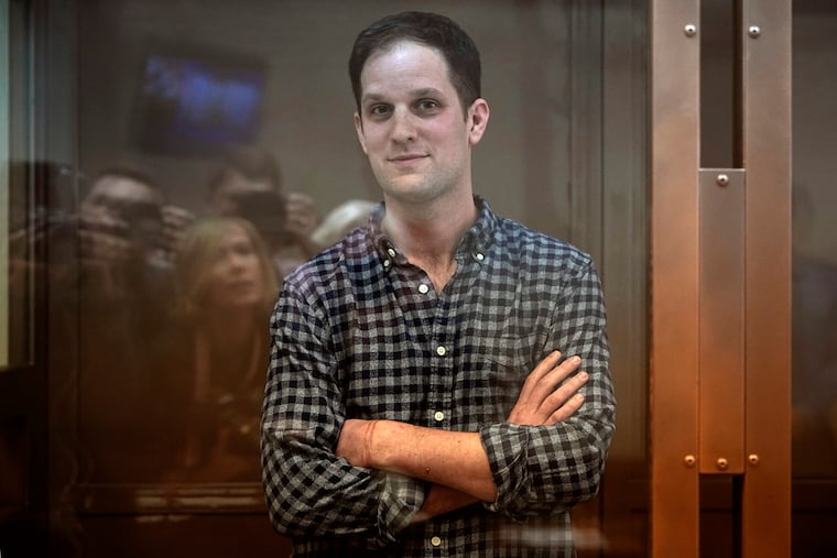 Wall Street Journal reporter Evan Gershkovich stands in a glass cage in a courtroom at the Moscow City Court, in Moscow, Russia, on Tuesday.