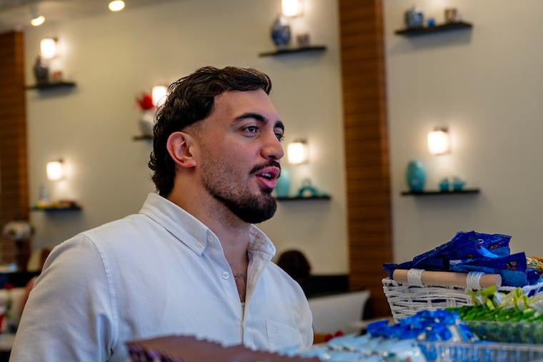 Muhammed Emanet greets diners at his family's restaurant, Jersey Kebab, in Collingswood on Sunday. The 2025 ICE arrests of his parents sparked wide condemnation and he now faces his own battle to stay in the United States. The Trump administration says that Emanet, who came here from Turkey as a boy, must leave and apply for his green card from his home country. That would separate him from his American-citizen wife and their two citizen children, probably for years at least, and potentially subject him to reprisals from the Turkish regime.