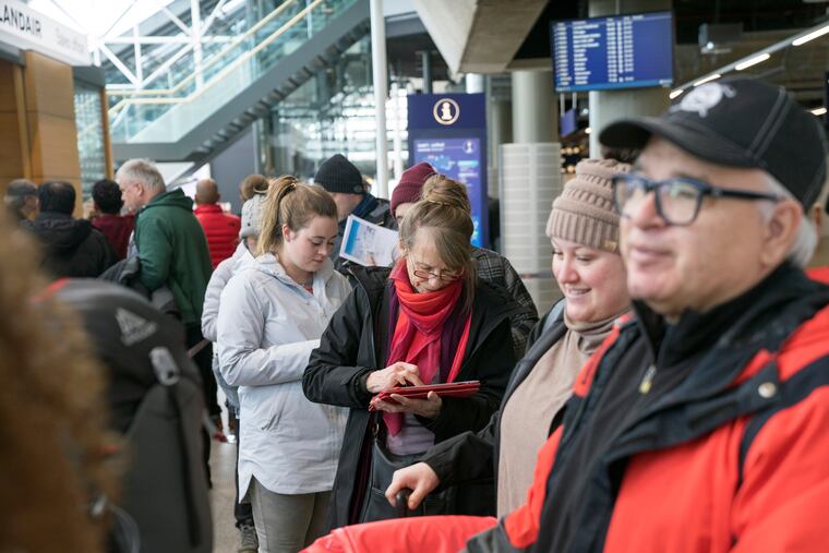 Stranded passengers set to travel with Icelandic airline Wow, wait in line at Iceland's international airport in Keflavik on Thursday, March 28, 2019. Icelandic budget airline WOW Air ceased operations on Thursday, stranding passengers across two continents. The airline told passengers that there would be no further flights and advised them to check flights with other airlines for ways to reach their destinations. (AP Photo/Egill Bjarnason)