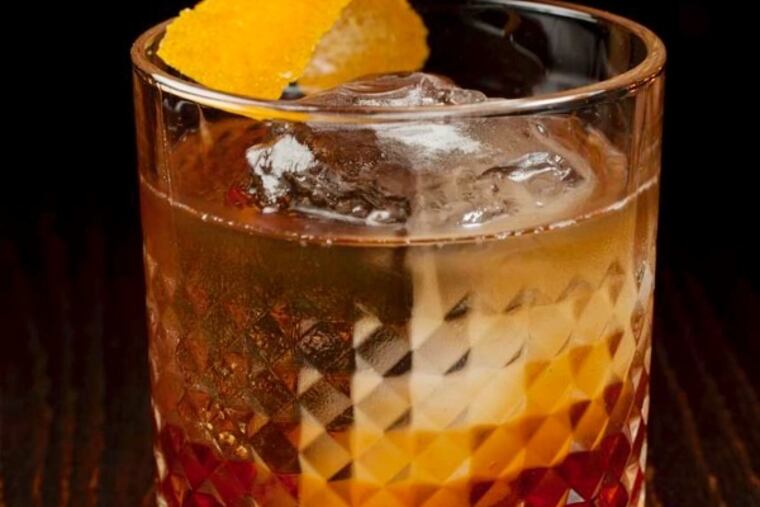 Escape Velocity with tobacco-infused Johnny Walker black, carpano antica, cherry heering and orange bitters as served at Charlie was a sinner., 131 S. 13th St., Philadelphia, October 2, 2014. ( DAVID M WARREN / Staff Photographer )