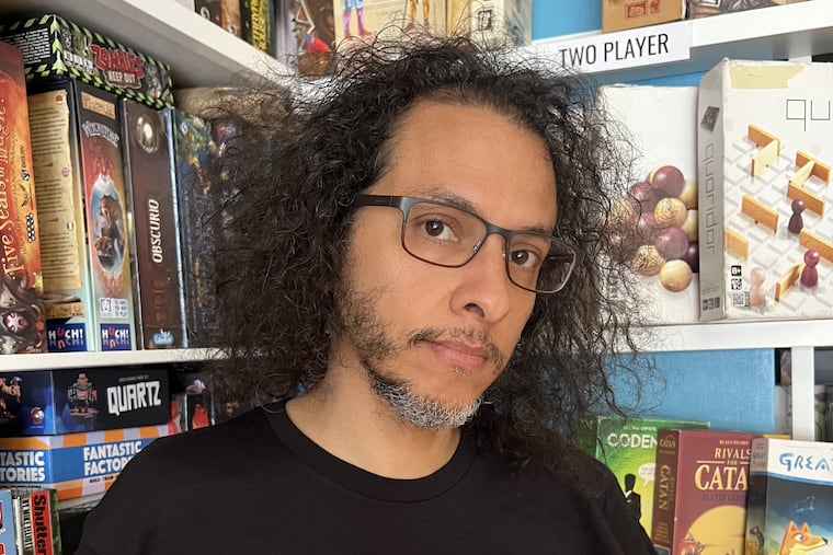 Edward Garcia, owner of the Queen & Rook Game Cafe at 2nd and South, says that in the wake of this weekend's violence near his shop, businesses can't afford to stay silent on gun control. Credit: Jeannie Wong