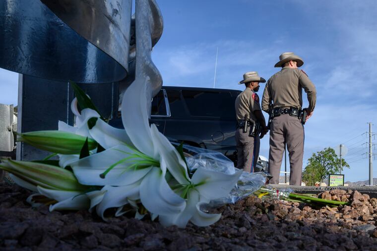 Police stand on duty outside the scene of the mass shooting in El Paso.